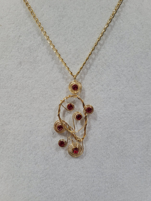 Gold pendant with red stones and chain